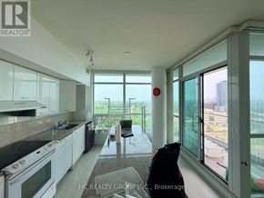 Toronto (Bayview Village) condo for rent - A kitchen with white cabinets and black countertops.