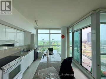 Toronto (Bayview Village) condo for rent - A kitchen with white cabinets and black countertops.