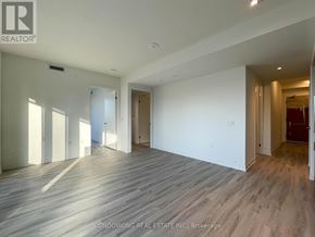 Toronto (Waterfront Communities) condo for rent - A spacious room with wooden flooring and white walls, part of a property managed by Condo/Wong Real Estate Inc.