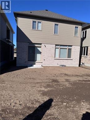 Paris apartment for rent - A house with a brown roof and a grey siding is shown in the image.