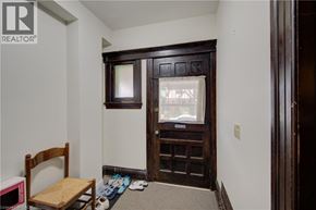 Hamilton apartment for rent - A room with a brown chair and a brown door.