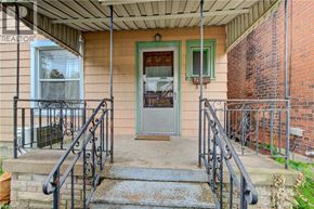 Hamilton apartment for rent - A house with a green door and a metal railing.