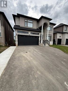 Hamilton (Ancaster) apartment for rent - A large house with a driveway in front of it.