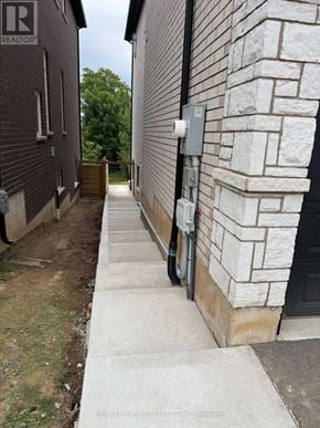 Hamilton (Ancaster) apartment for rent - A stone building with a Realty sign on it.