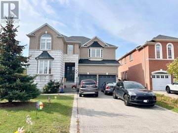 Richmond Hill (Rouge Woods) apartment for rent - A large house with a black car in front.