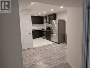 Halton Hills (Georgetown) apartment for rent - A kitchen with a refrigerator, microwave, and oven.