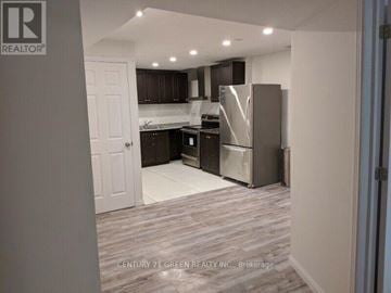Halton Hills (Georgetown) apartment for rent - A kitchen with a refrigerator, microwave, and oven.