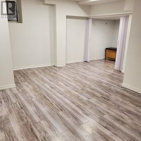 Halton Hills (Georgetown) apartment for rent - A room with a wooden floor and white walls.