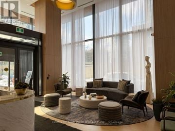 Toronto (Willowdale East) condo for rent - A living room with a large window and a variety of furniture.