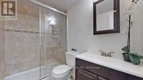 Toronto (Crescent Town) condo for rent - A bathroom with a toilet, sink, and shower.