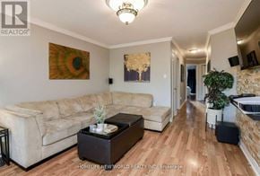 Bradford West Gwillimbury (Bradford) apartment for rent - A living room with a beige couch and a brown coffee table.