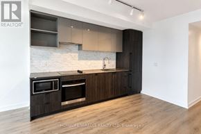 Toronto (Church-Yonge Corridor) condo for rent - A modern kitchen with dark wood cabinets and a marble backsplash.