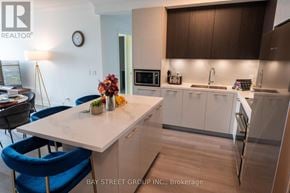 Markham (Unionville) condo for rent - A kitchen with a table and chairs in front of a counter.
