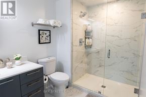 Markham (Unionville) condo for rent - A white toilet sits next to a white sink in a bathroom.