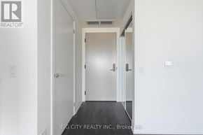 Toronto (Thorncliffe Park) condo for rent - A hallway with a door at the end and a logo on the wall.