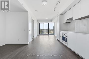 Toronto (Thorncliffe Park) condo for rent - A spacious kitchen with white cabinets and a large window.