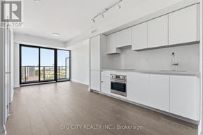 Toronto (Thorncliffe Park) condo for rent - A spacious kitchen with white cabinets and a large window.