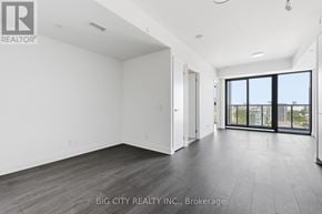 Toronto (Thorncliffe Park) condo for rent - A spacious room with a sliding glass door leading to a balcony.