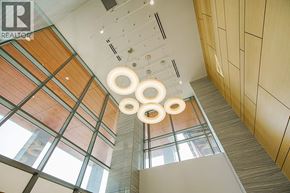 Burnaby apartment for rent - A modern interior with wooden ceiling and hanging lights.