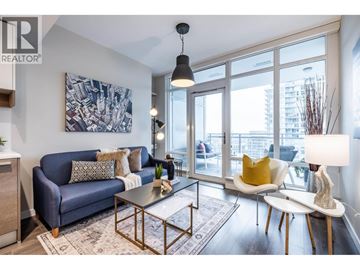 Burnaby apartment for rent - A living room with a blue couch and a painting on the wall.