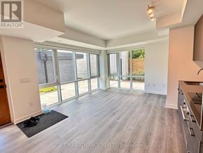Toronto (Parkwoods-Donalda) townhouse for rent - A spacious living room with a sliding glass door leading to a backyard.