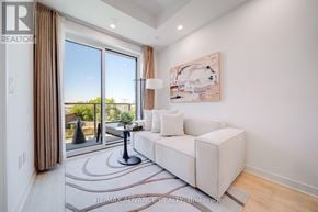 Toronto (Parkwoods-Donalda) townhouse for rent - A living room with a white couch and a painting on the wall.