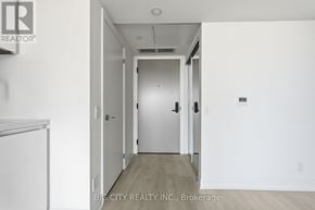 Toronto (Thorncliffe Park) condo for rent - A hallway with a door on the right and a white wall on the left.