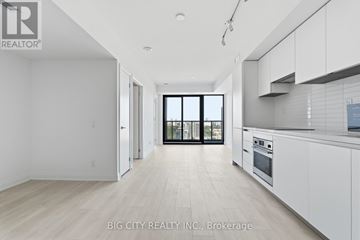 Toronto (Thorncliffe Park) condo for rent - A spacious kitchen with white cabinets and a large window.