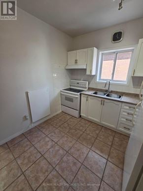 Hamilton (Landsdale) apartment for rent - A kitchen with white cabinets and a tile floor.