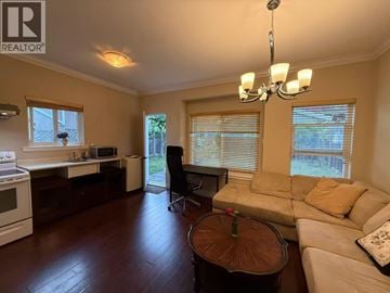 Burnaby apartment for rent - A living room with a brown table and a white couch.