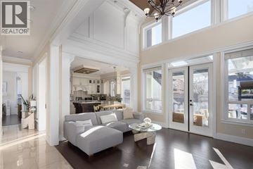 Richmond apartment for rent - A living room with a grey sofa and a chandelier.