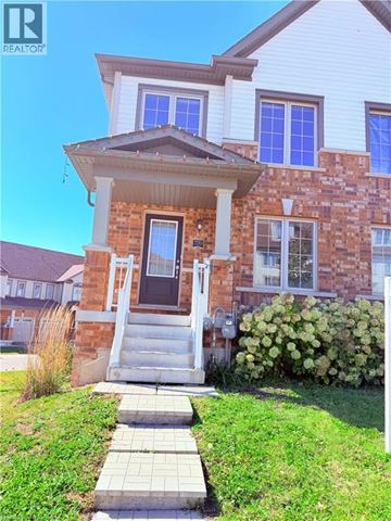 Cambridge townhouse for rent - A house with a brick facade and a white porch.
