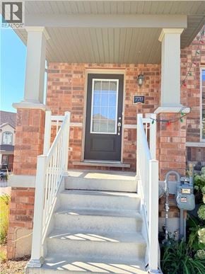 Cambridge townhouse for rent - A house with a black door and a white railing.