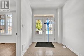 Caledon townhouse for rent - A hallway with a door and a window.
