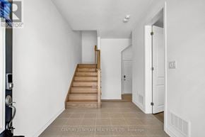 Caledon townhouse for rent - A hallway with a staircase leading to the second floor.