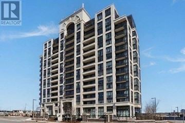 Markham (Wismer) condo for rent - A tall residential building with a clear blue sky in the background.