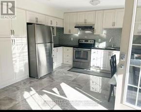 Vaughan (Patterson) apartment for rent - A kitchen with a refrigerator, microwave, oven, and sink.