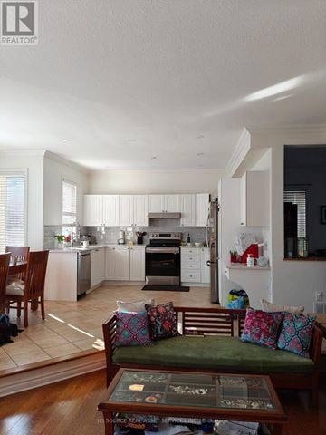 Ottawa apartment for rent - A well-lit kitchen with a dining table and chairs.