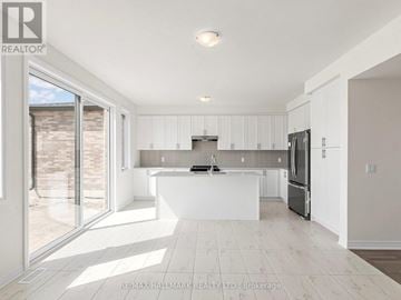 Whitby (Brooklin) apartment for rent - A modern kitchen with white cabinets and a large island.