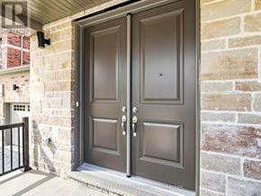 Whitby (Brooklin) apartment for rent - A double door with a black handle and a small window in the middle.