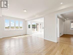 Whitby (Brooklin) apartment for rent - A spacious room with wooden flooring and white walls.