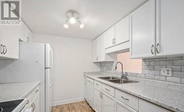 London North (North G) condo for rent - A white kitchen with a sink and a refrigerator.