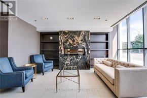 Burlington (Uptown) condo for rent - A living room with a fireplace and blue chairs.