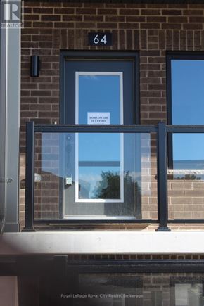 Guelph (Clairfields/Hanlon Business Park) townhouse for rent - A window with a sign that says "For Rent" is on a brick building.