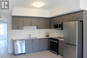 Guelph (Clairfields/Hanlon Business Park) townhouse for rent - A kitchen with a white counter top and grey cabinets.