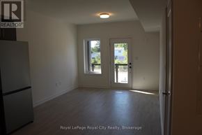 Guelph (Clairfields/Hanlon Business Park) townhouse for rent - A white room with a door and a window.