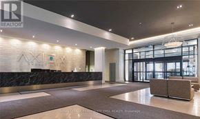 Toronto (Moss Park) condo for rent - A reception area with a marble counter and a logo on the wall.