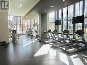 Toronto (Moss Park) condo for rent - A gym with treadmills and weights is shown.