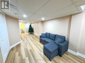 Blue Mountains townhouse for rent - A living room with a grey couch and a Christmas tree.