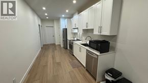 North Vancouver apartment for rent - A kitchen with wooden floors and white walls.